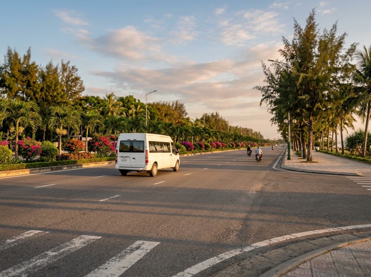 Wide city road junction with cars and motorbikes on the route towards Da Nang airport